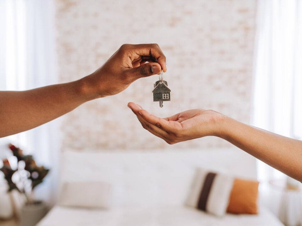 Real estate agent giving a man the keys to his new home